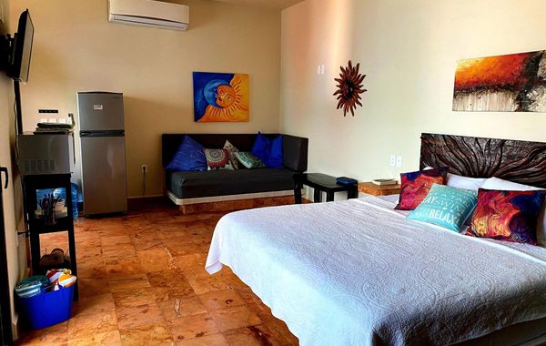 The Sol Studio Suite with balcony overlooking the pool and garden area - Hoteles con parque acuático en Isla Mujeres, México