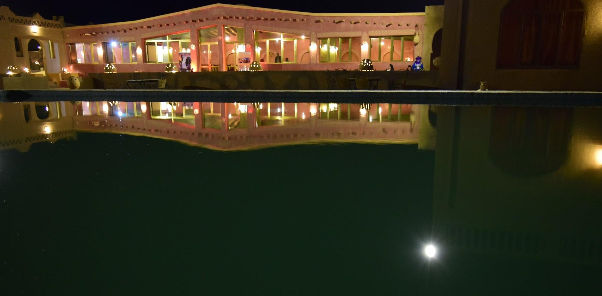 Vista Piscina Palmeras y Dunas
