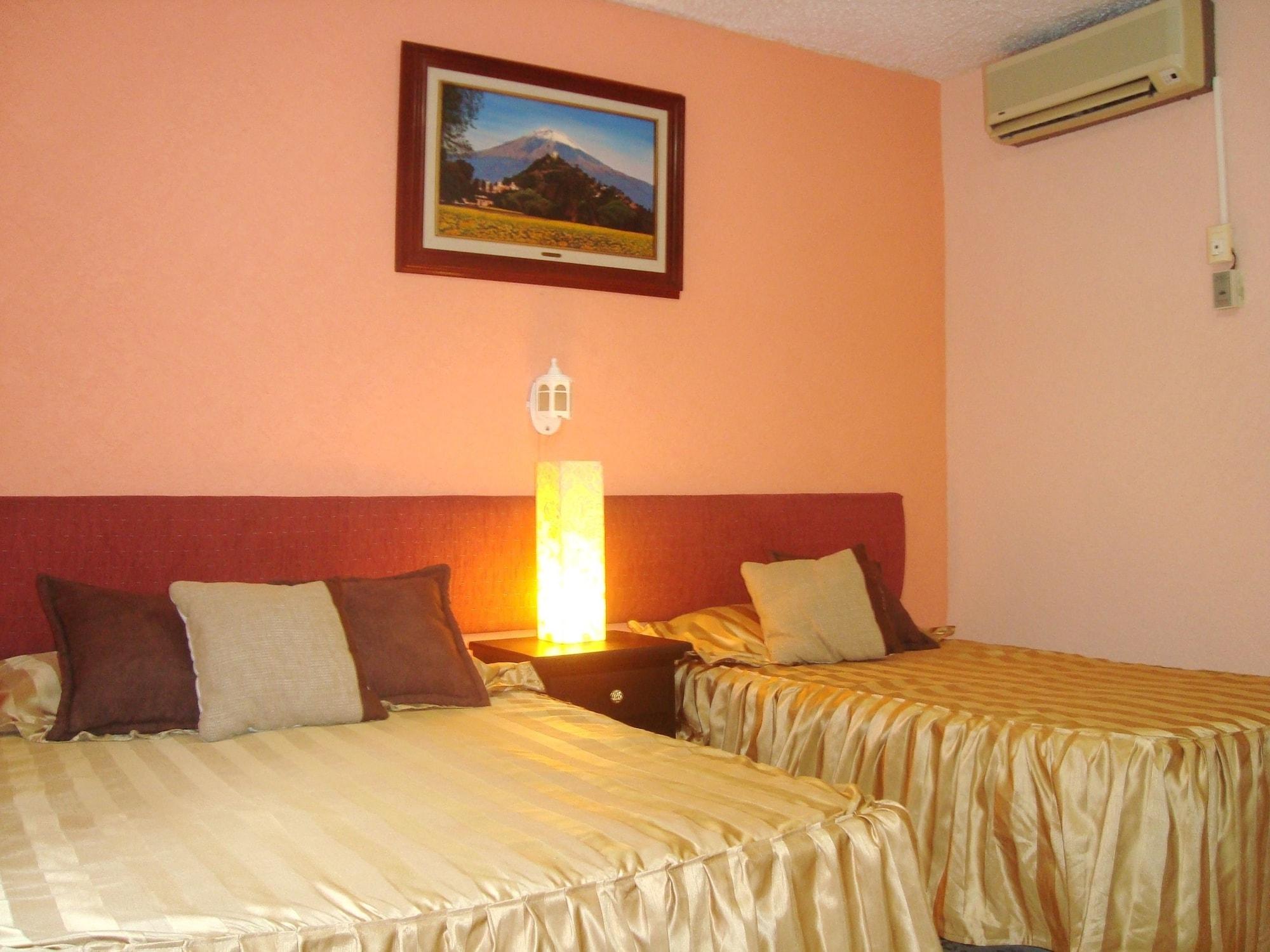 Habitación Suites Angelopolis